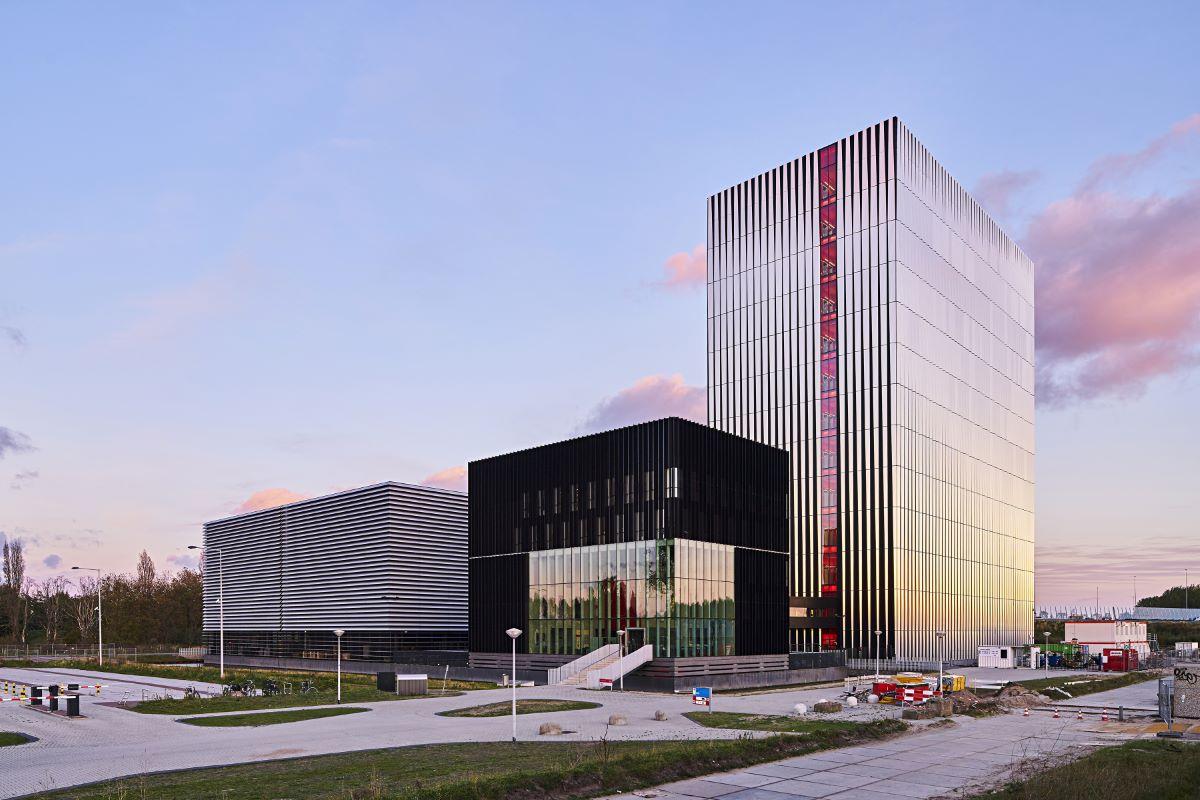 A large data center against a blue/purple sky.