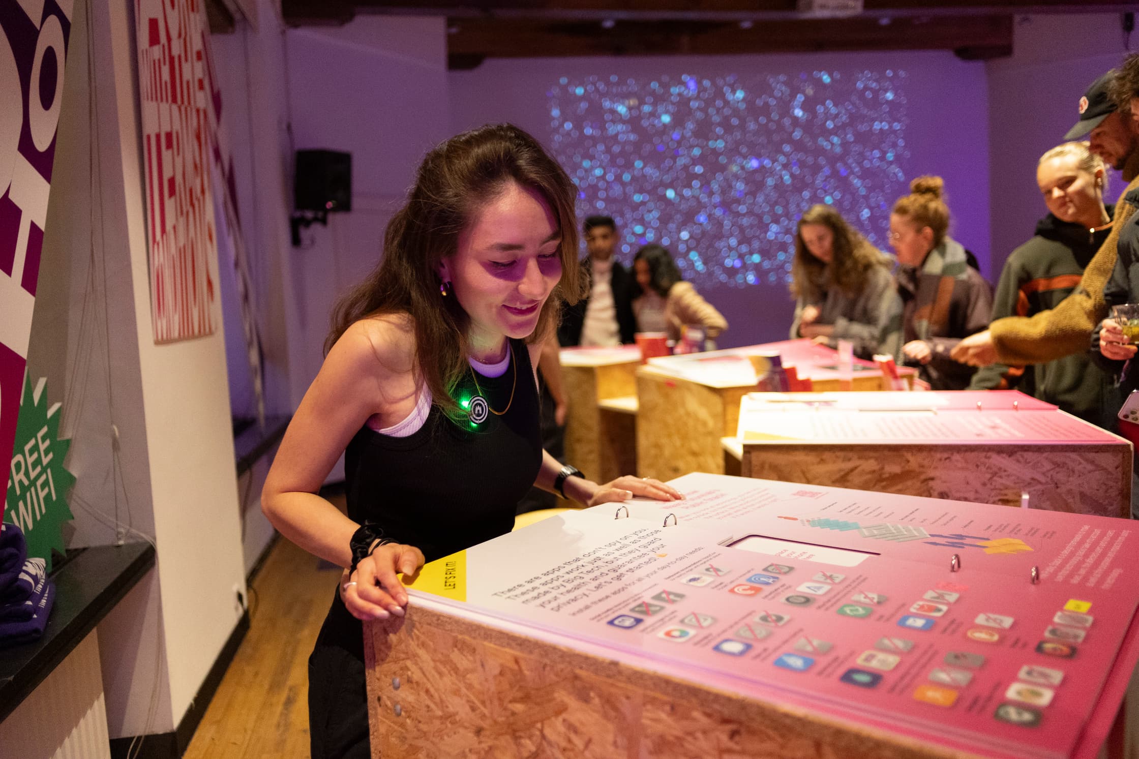A person standing infront of an inphographic about apps